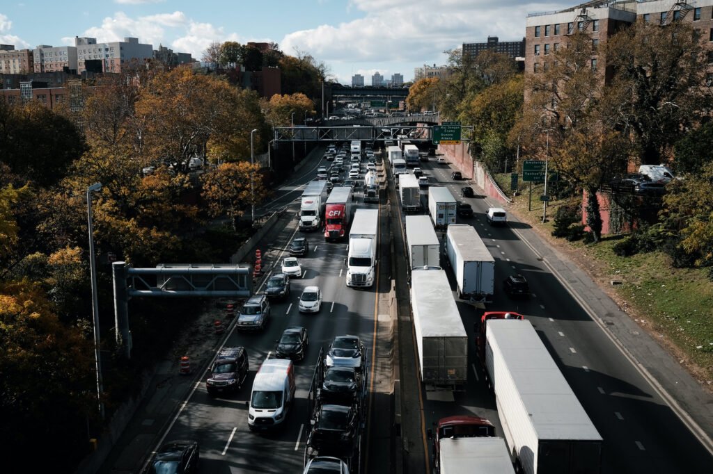 Port truck traffic idling on a dense highway corridor near residential apartment buildings